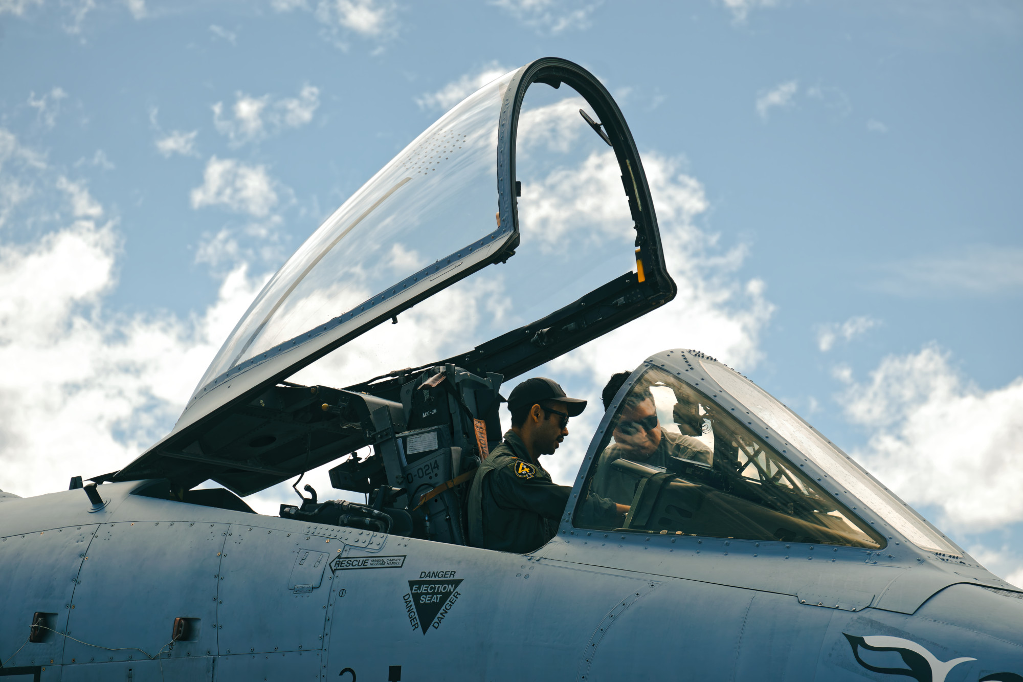 Pilots getting into an airplane cockpit